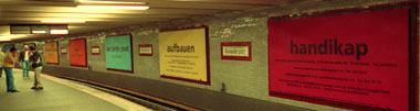 billboards opposite the waiting platform, including addresses + phone numbers